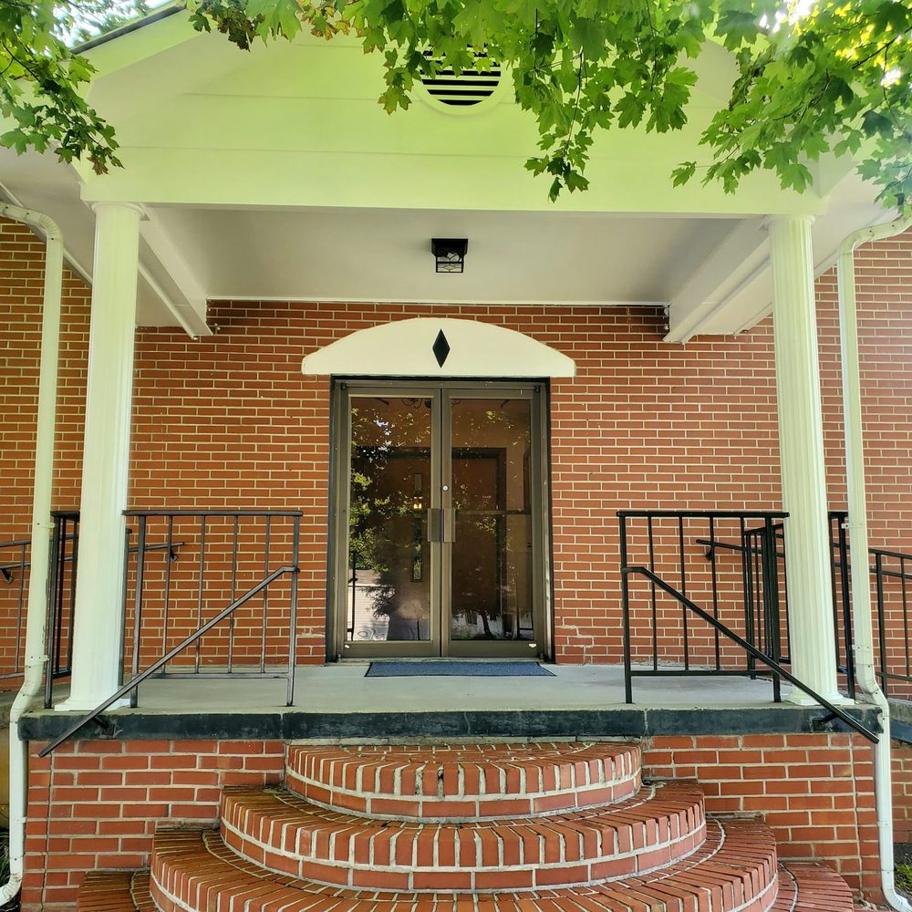 The brick front porch, rounded steps and glass doors of Star Bethel