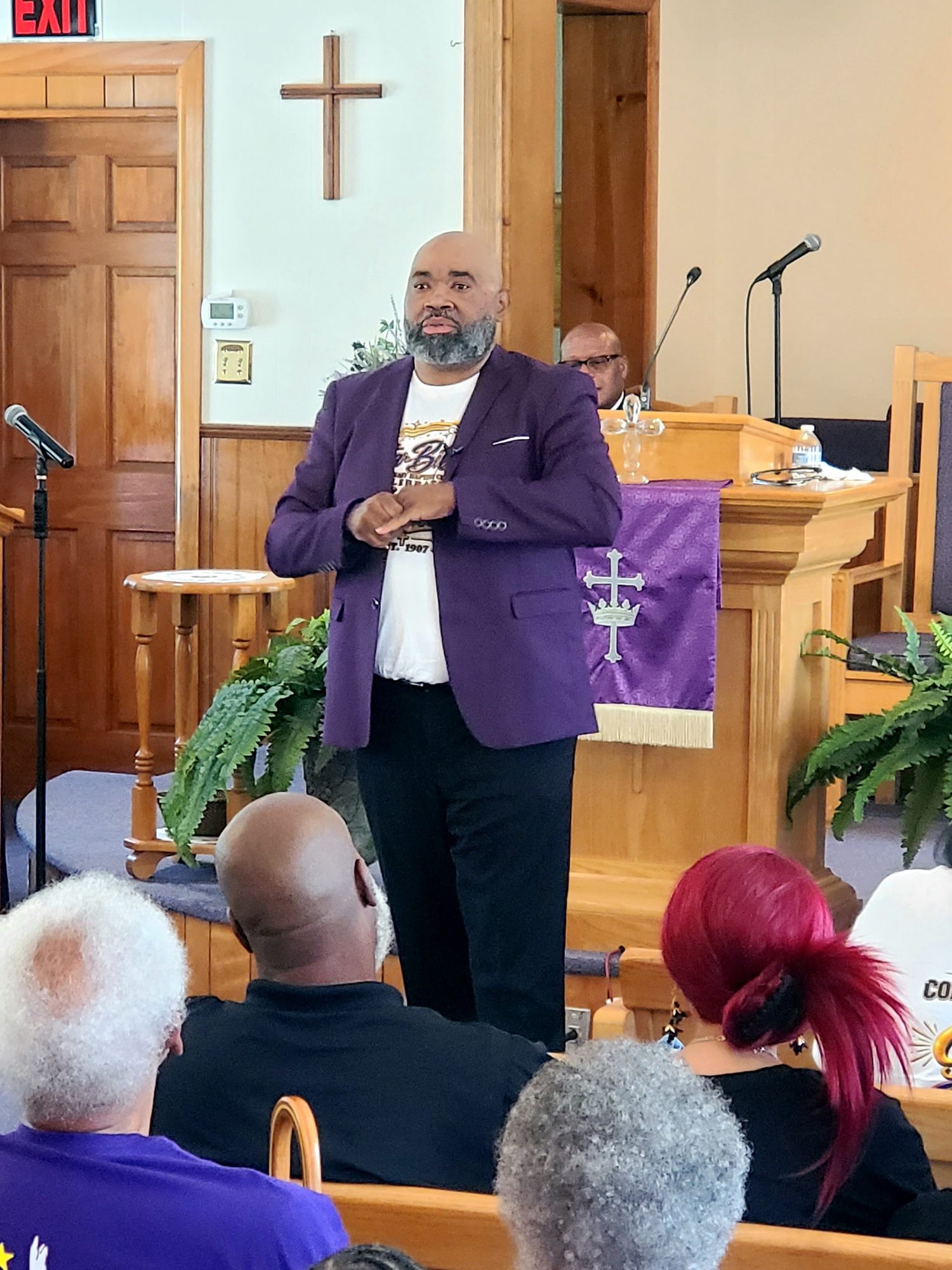 Pastor Marvin Parks speaking at the pulpit during Sunday worship