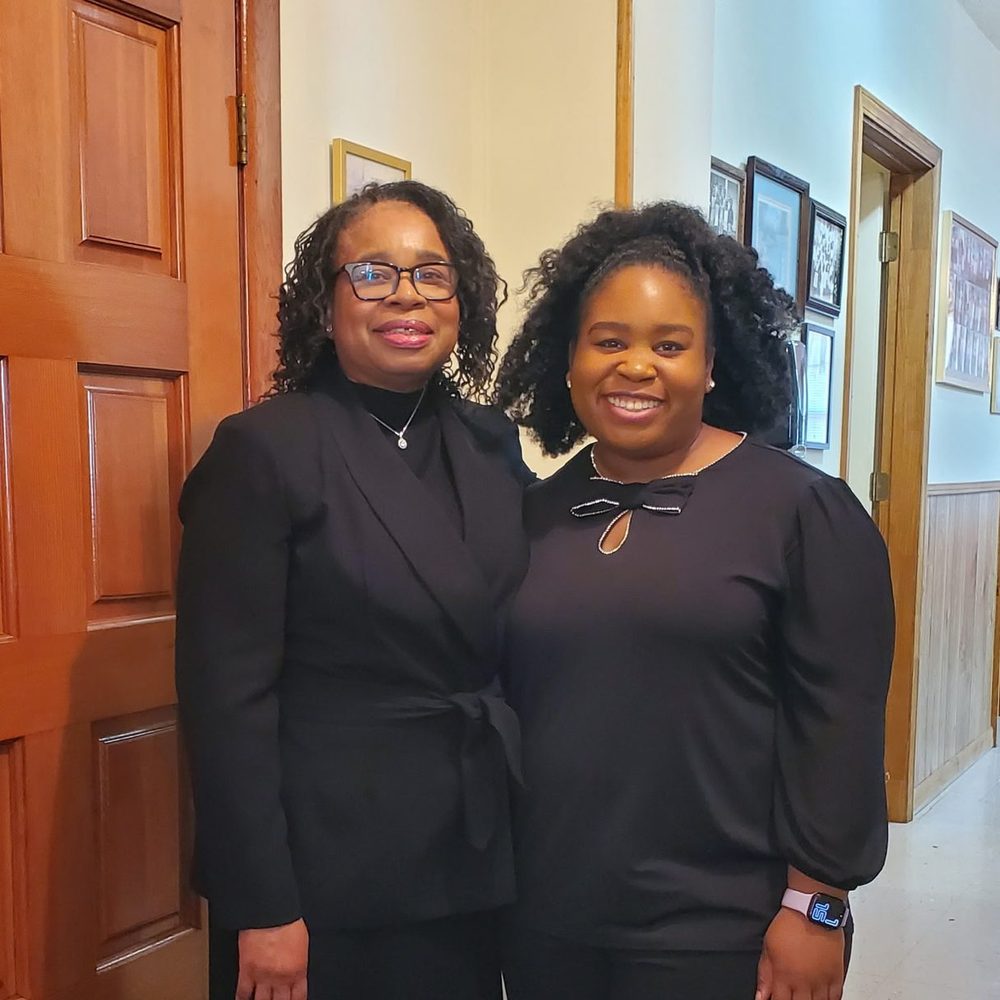 Two members of Star Bethel smiling together in the sanctuary